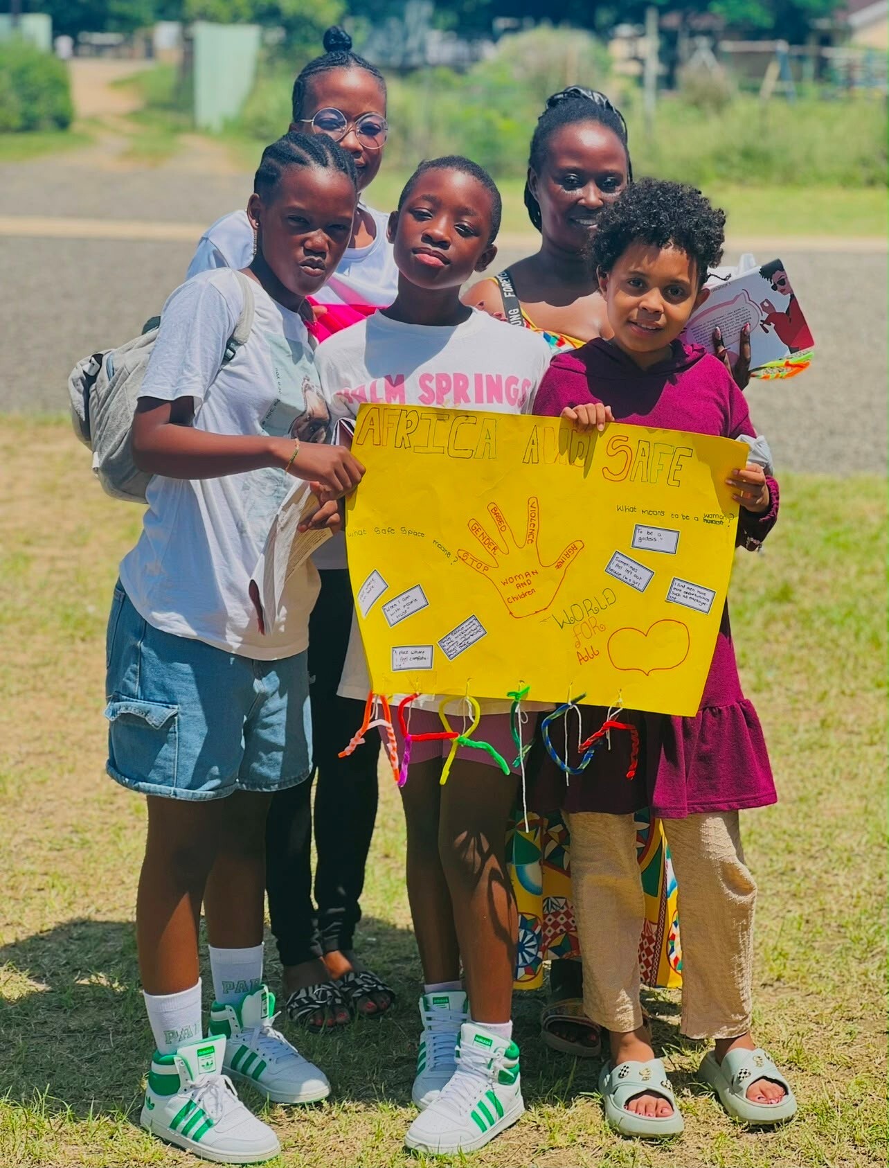 A local family in Zululand holding the poster they made at the Project Brave Space workshop