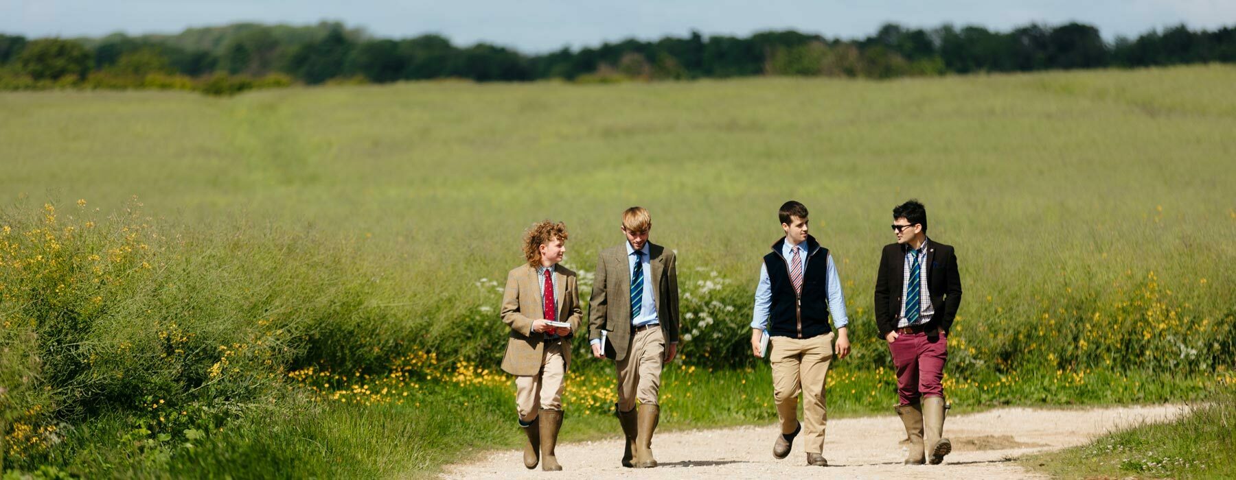 Agri banner Agriculture college students walking past arable fields