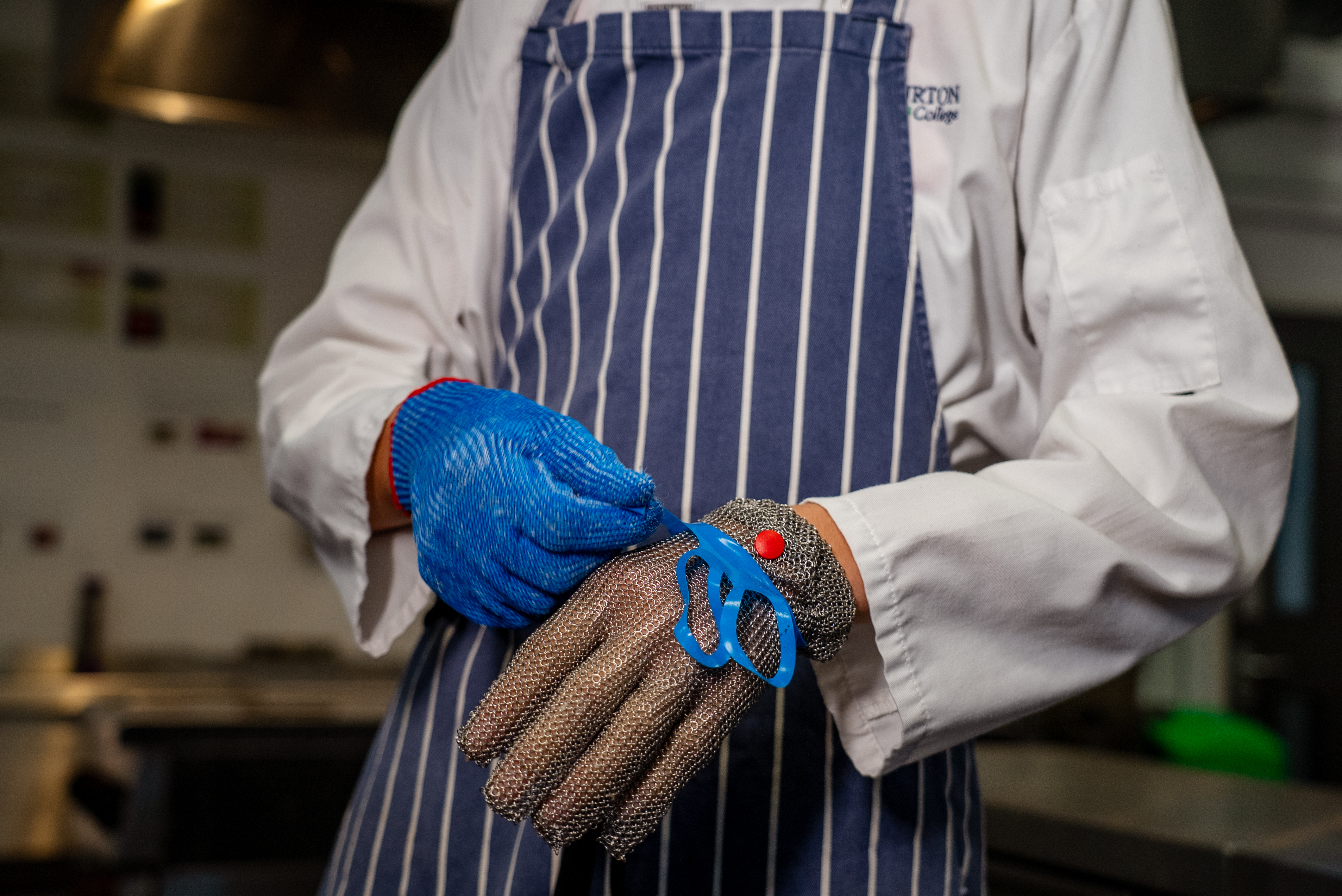 Apprentice putting protective gloves on