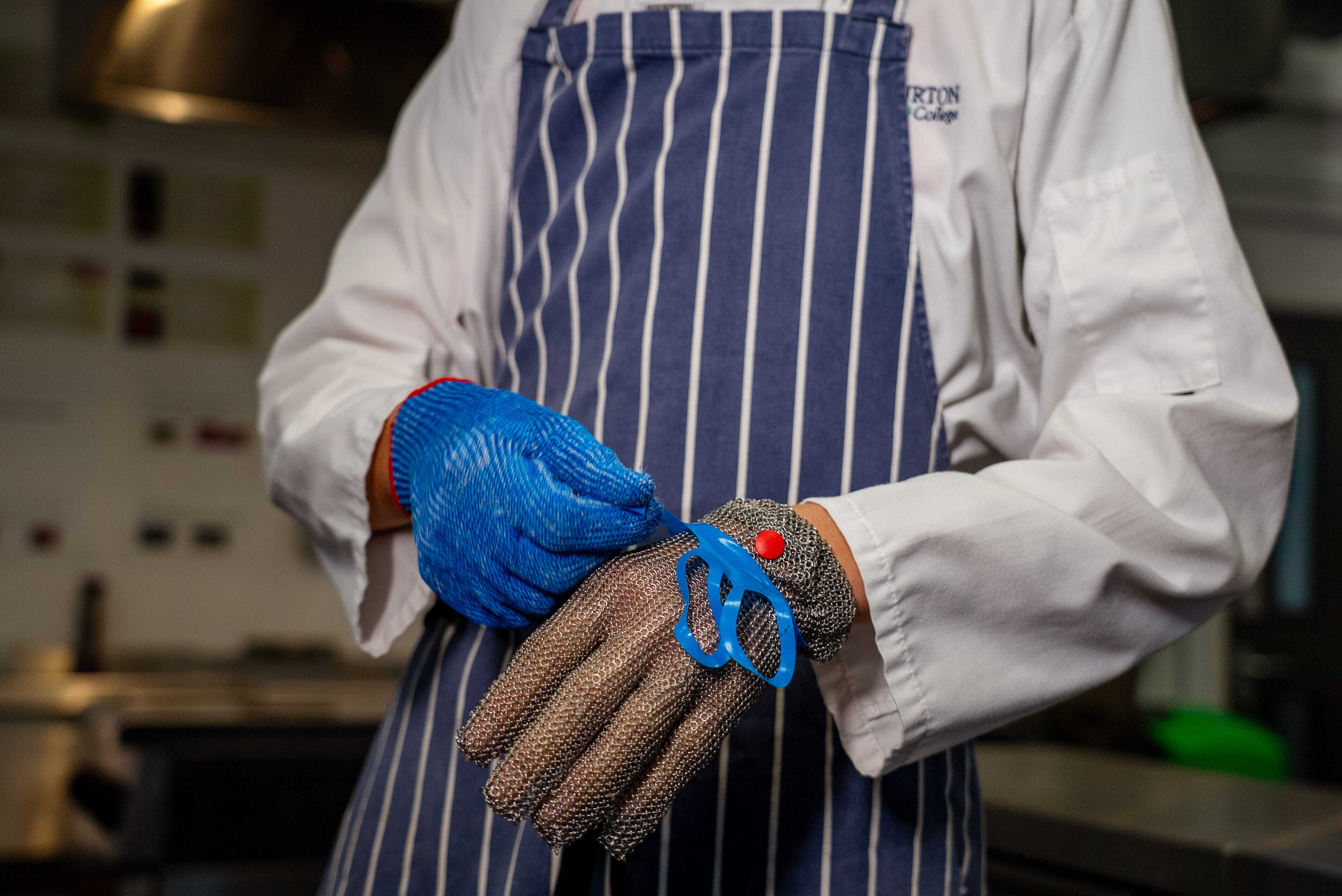 Apprentice putting protective gloves on