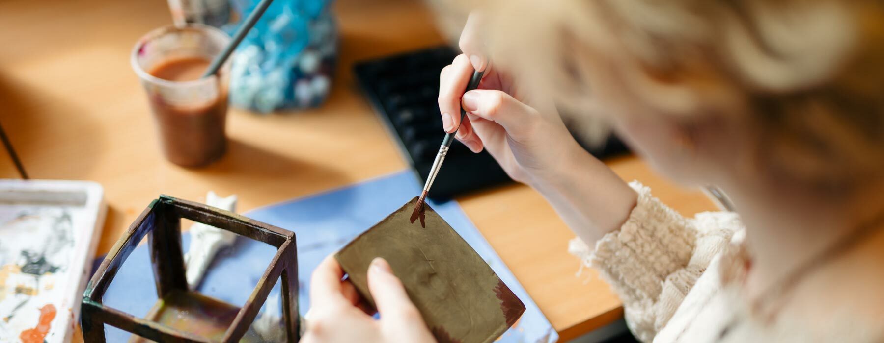Art and design student painting clay