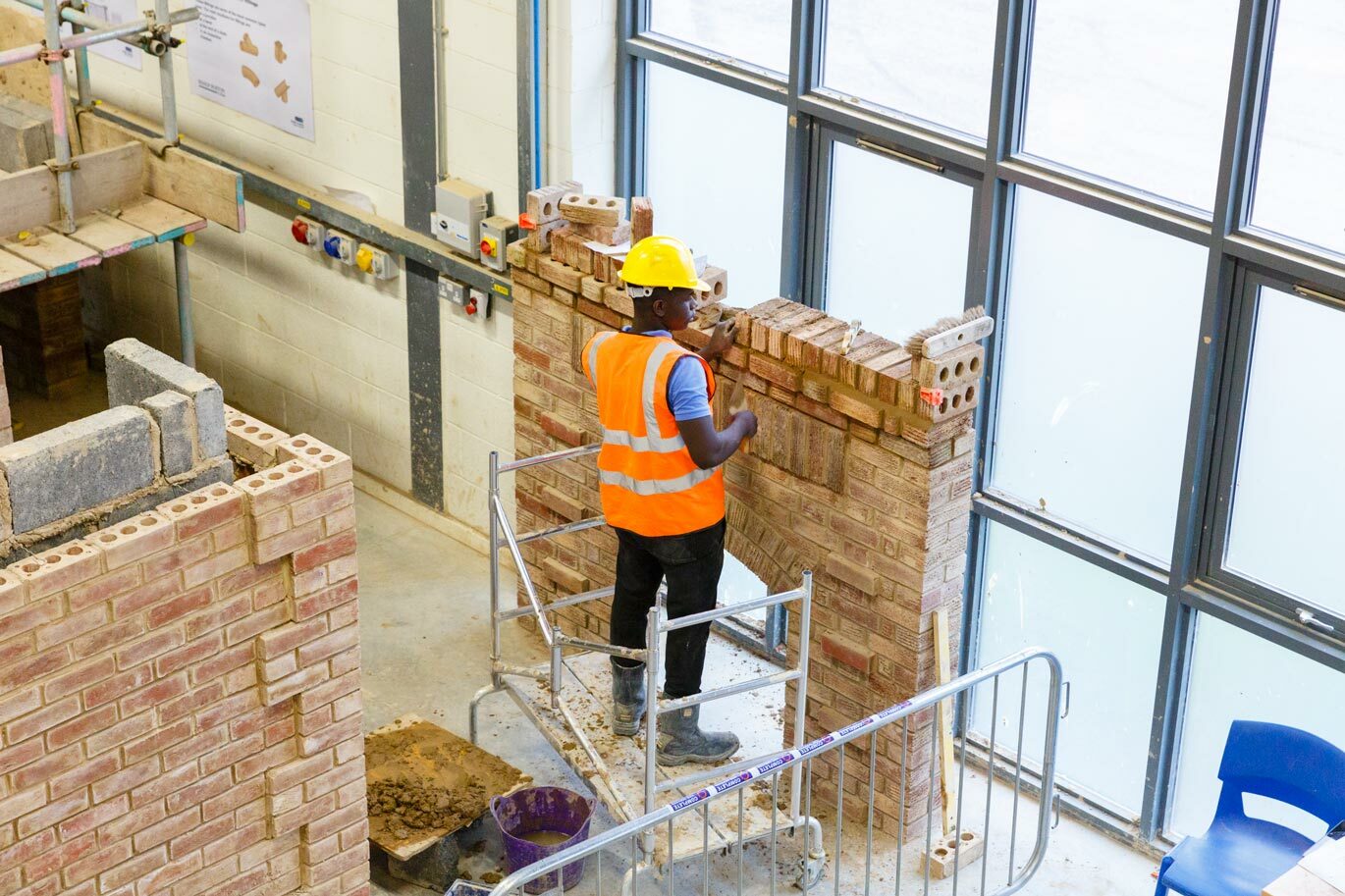 Bricklaying student working on wall