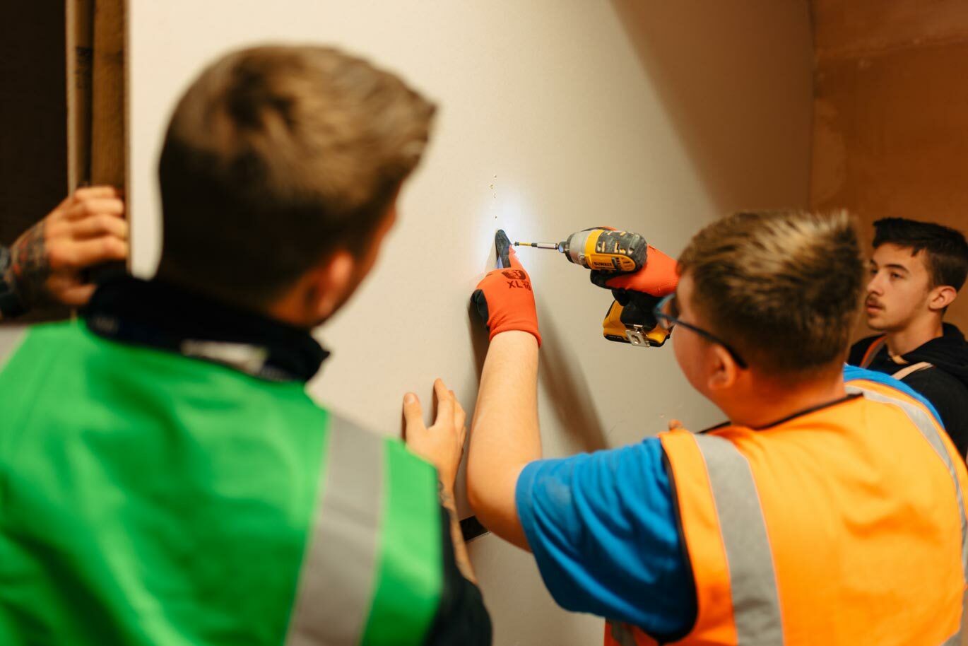 College student drilling plasterboard