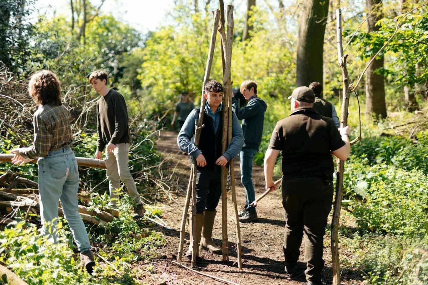 Country gallery Students clearing tree branches for countryside course