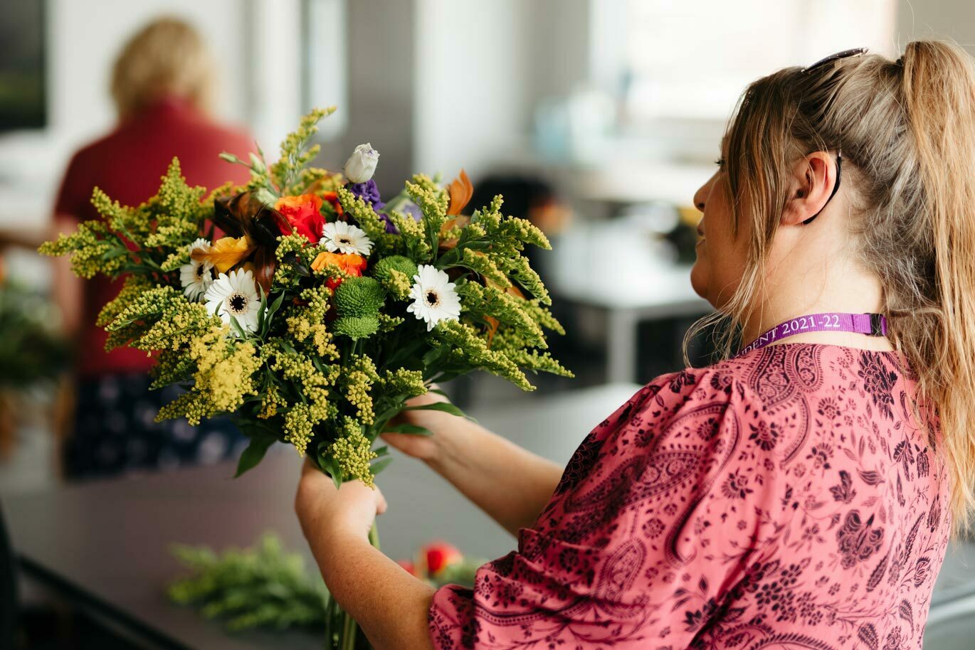 Floristry gallery Degree student holding bouquet of flowers