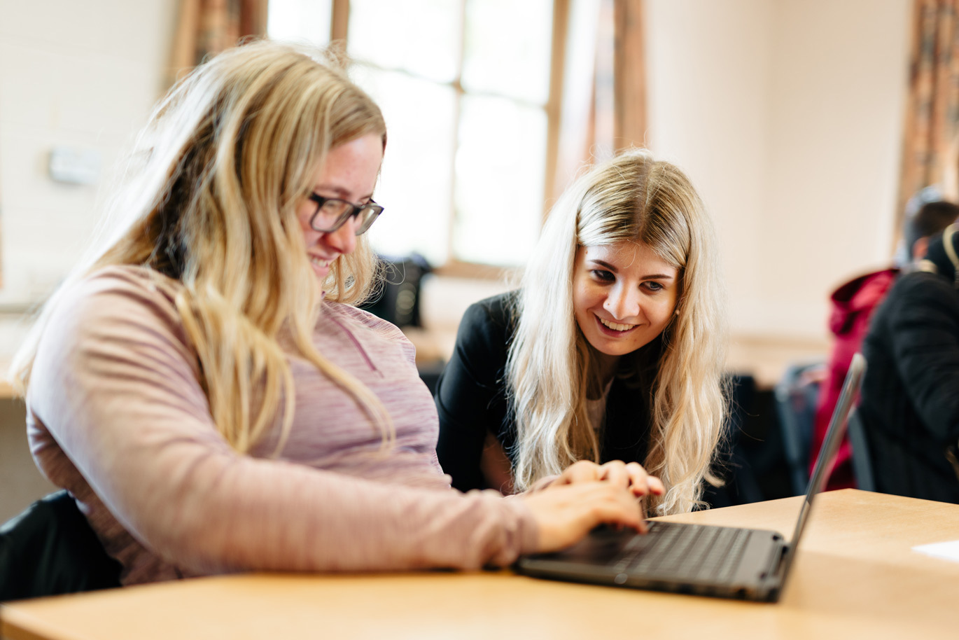 Foundation callout Students smiling at laptop work