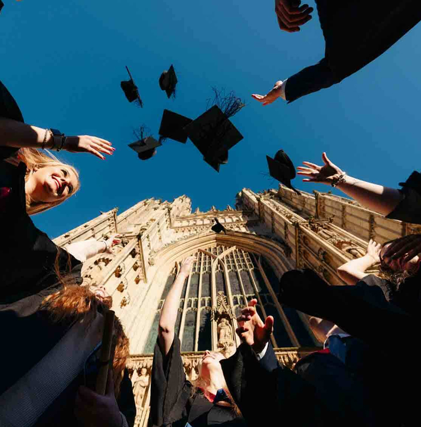 Graduates throwing hats in the air