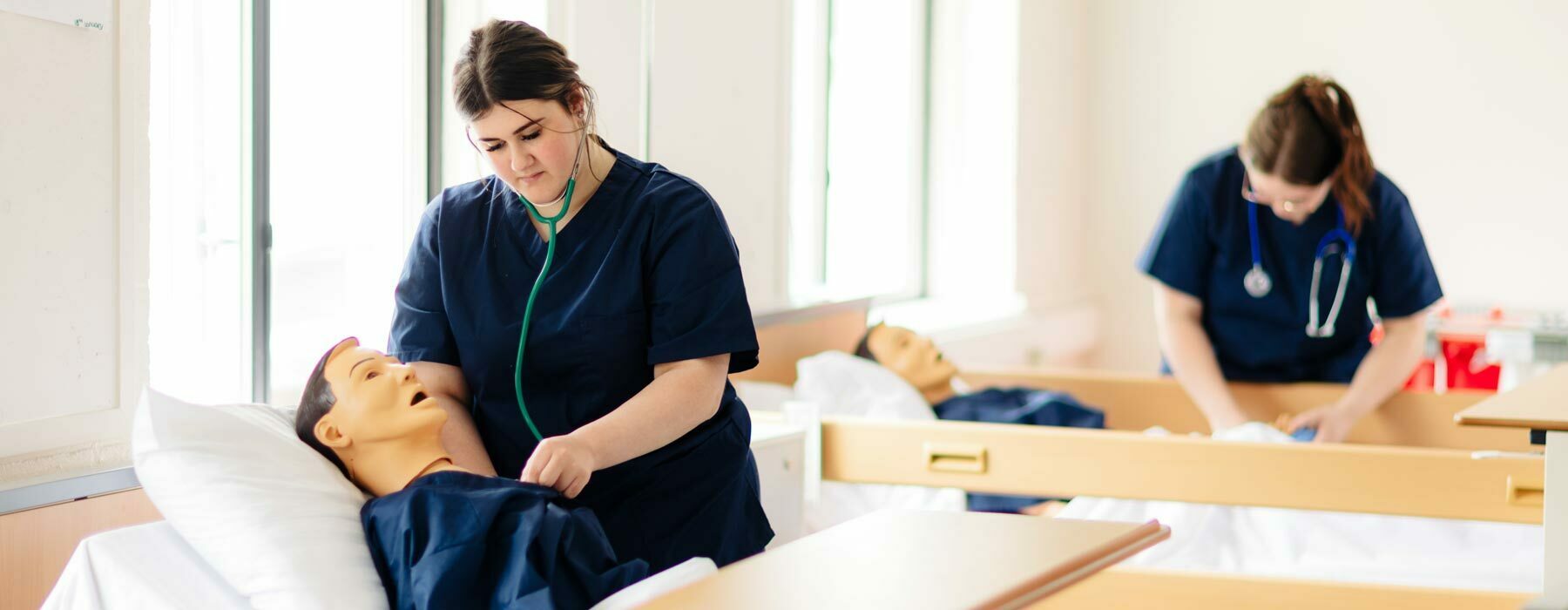 Health and social banner College students in Health Suite at Bishop Burton