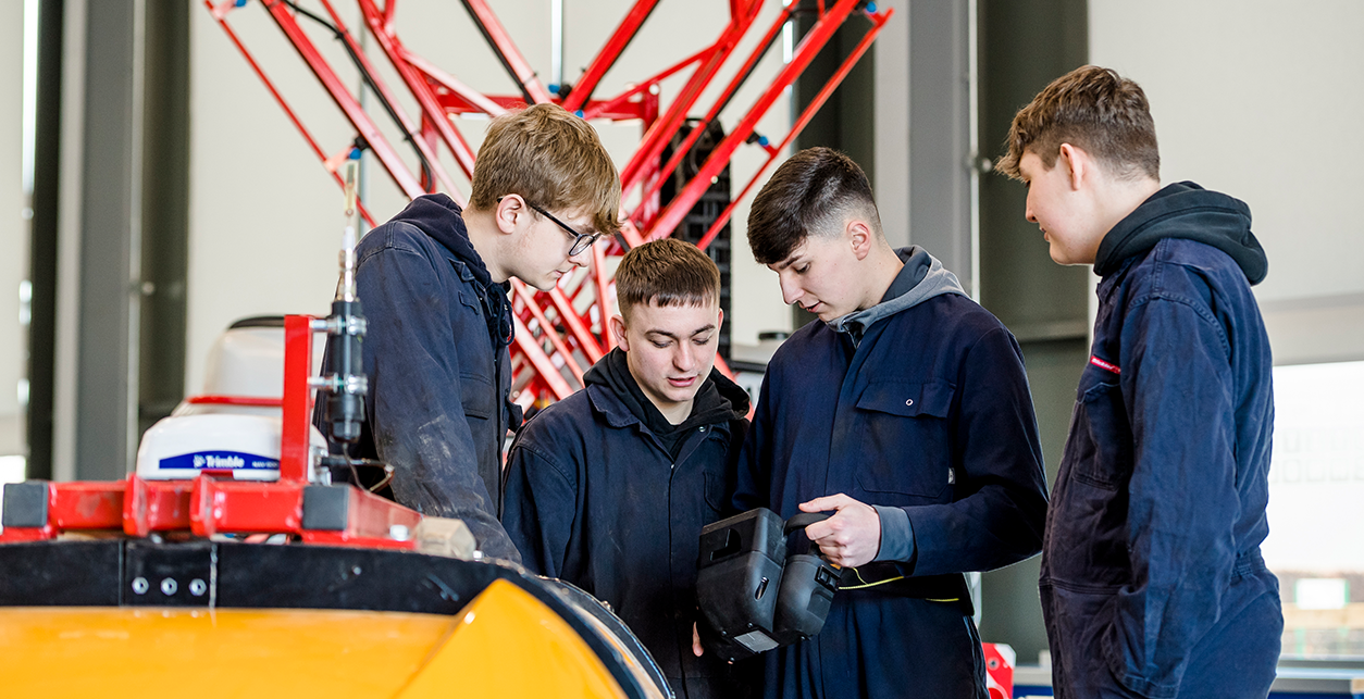 Io T students working on equipment in the classroom