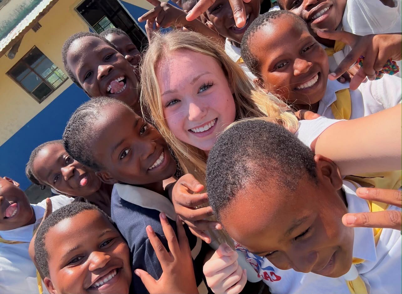 Lillie Rose Pilkington 18 who was part of the team that helped establish Project Brave Space surrounded by some of the local children in Zululand