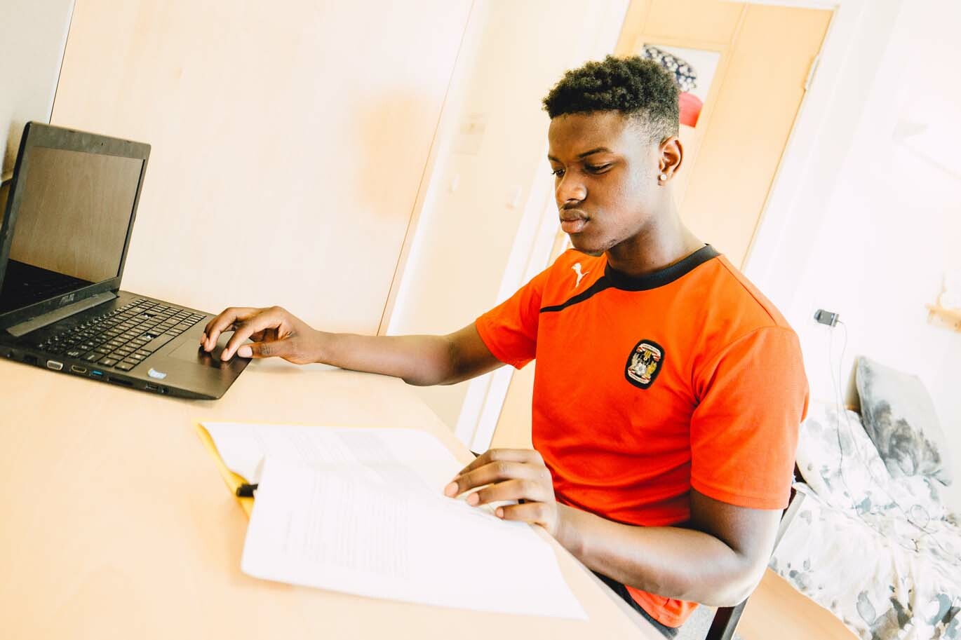 Male student working in his room at Bishop Burton College
