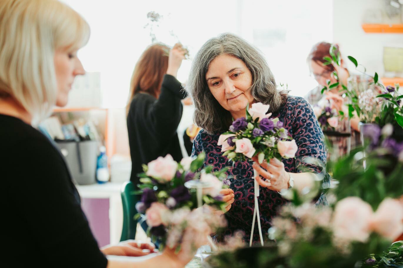Student on Floristry course holding mini bouquet