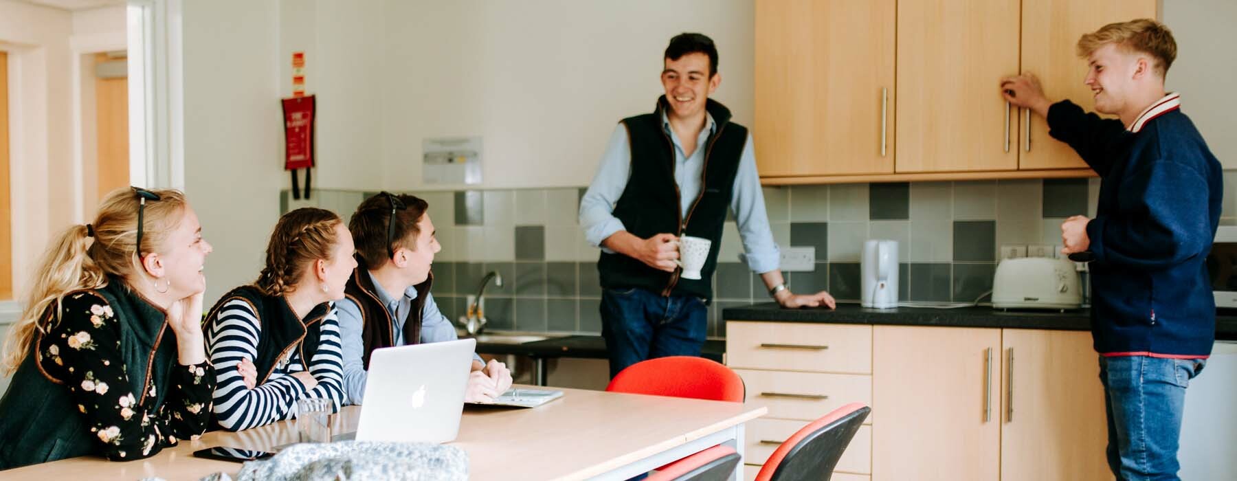 Students socialising in kitchen in accommodation