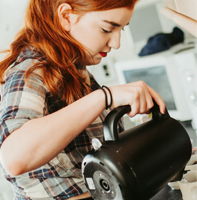 Student pouring a kettle